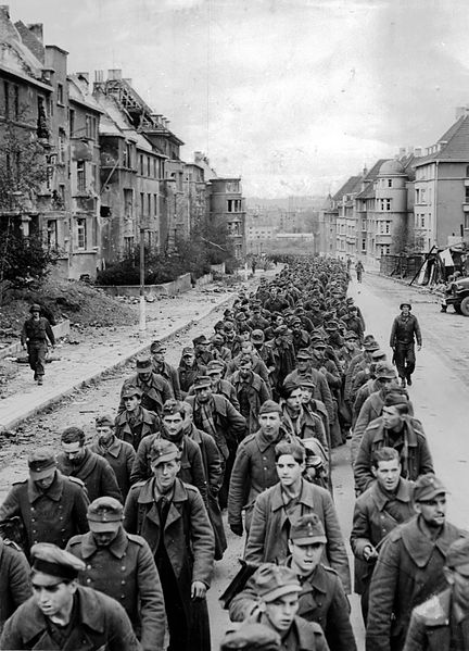 Prisoners of war. Original Title: "The endless procession of German prisoners captured with the fall of Aachen marching through the ruined city streets to captivity."
